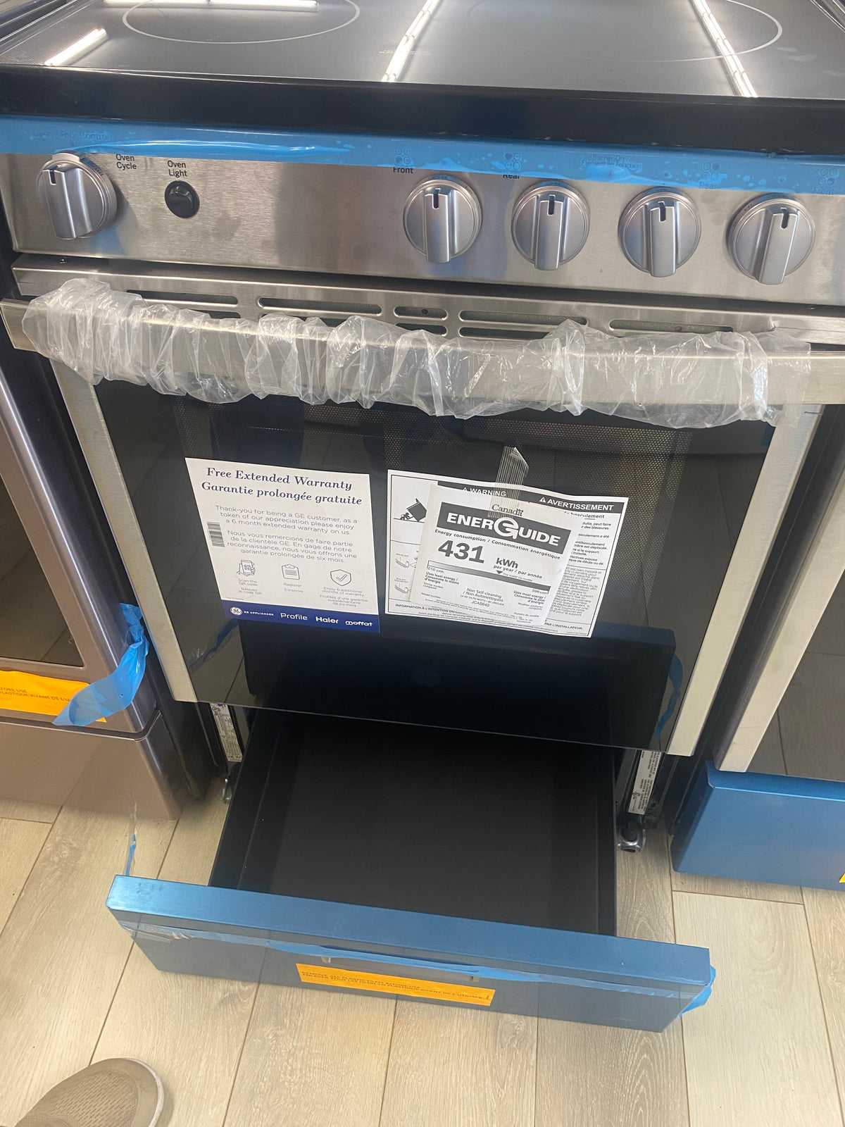 24” GE glass top stove, slide In, "Brand New"